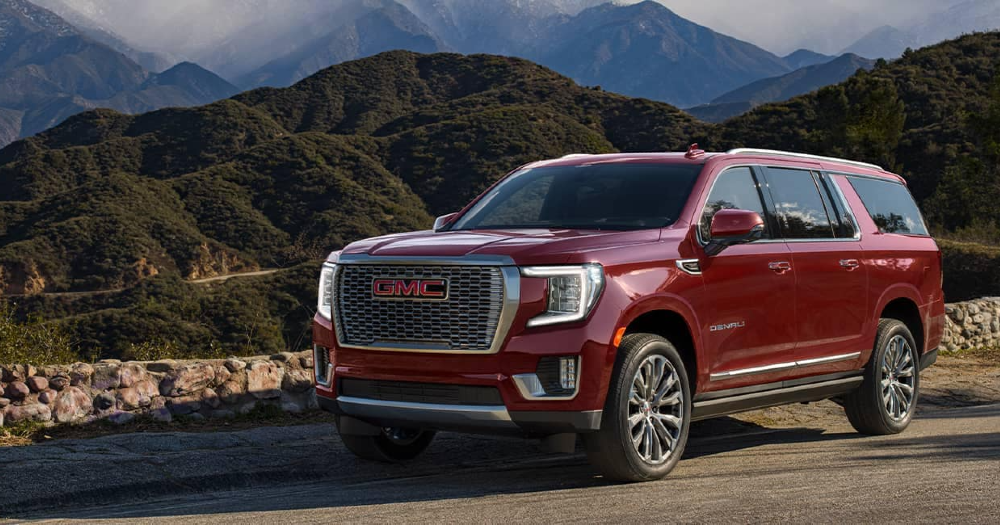 2021-Cayenne-Red-Yukon-XL-Denali-in-front-of-a-mountain